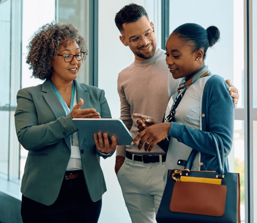 Woman demonstrating agentic AI-driven data on tablet to a couple.