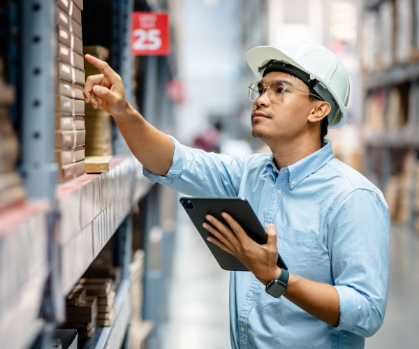 Factory worker managing inventory with the help of agentic AI.