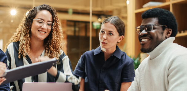 Agile developers smiling as they have a meeting.
