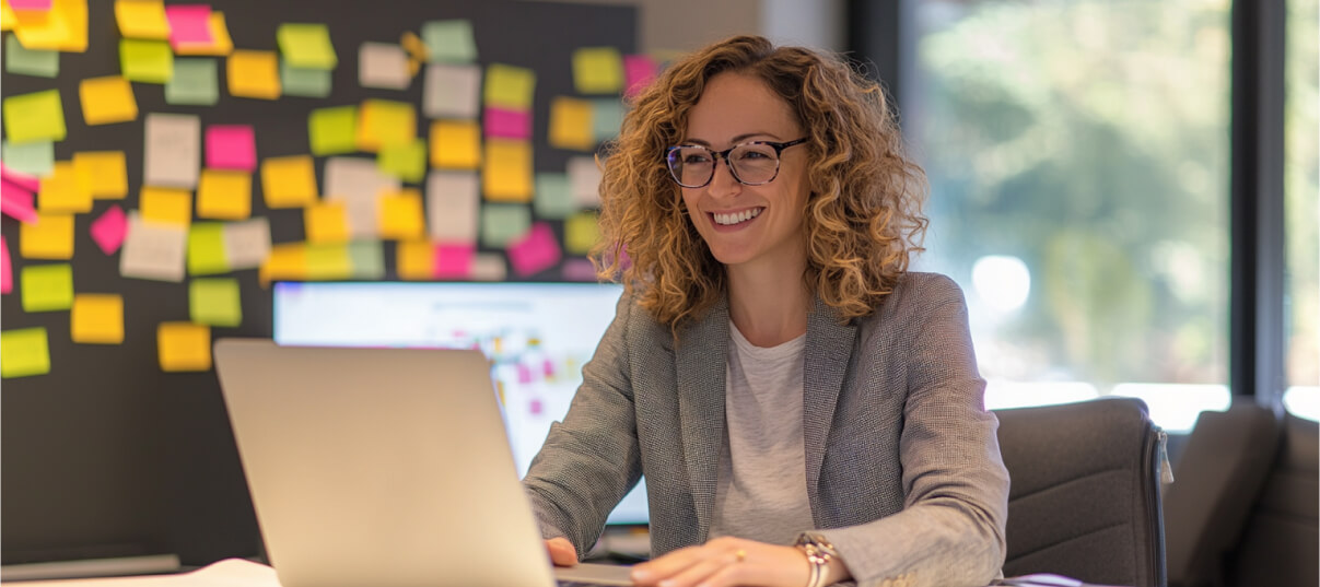 Developer smiling at computer while using E-ZPR to review code