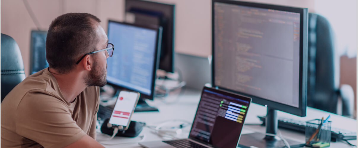 Developer working on computer and reviewing code