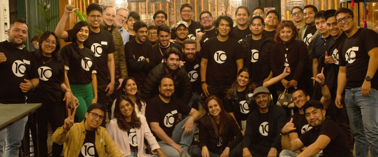 Group photo of the 10Pearls nearshore development team, smiling at a company outing.