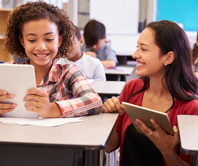 Teacher and student smiling while working together on a custom e-learning software