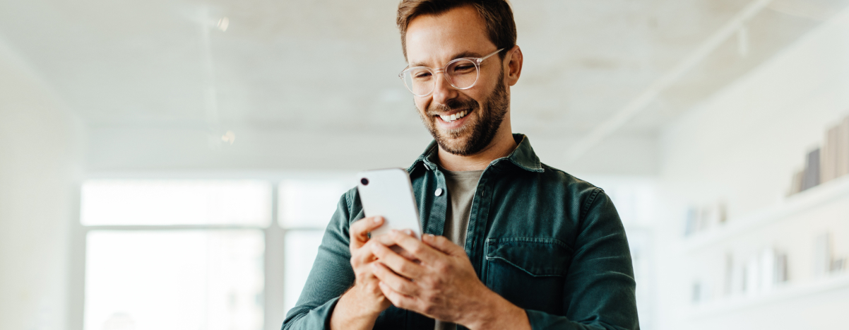 Man smiling while using AI mobile app on phone.