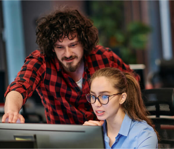 QA engineer reviewing code on computer with GenAI.