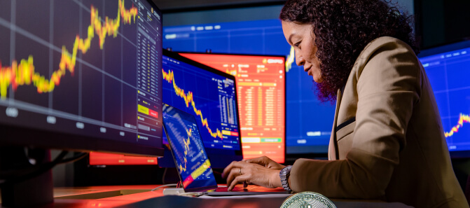 Bitcoin coins in front of trading chart, illustrating blockchain services for decentralized crypto vaults.