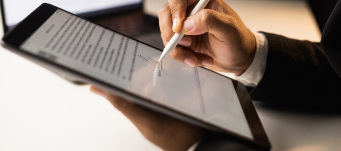 Signing a smart contract on tablet, showing blockchain development services for secure agreements.