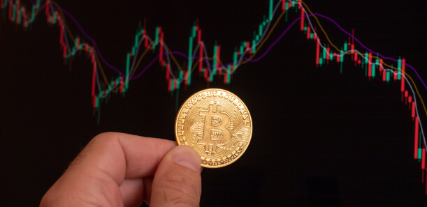 Bitcoin coin in front of trading chart representing utility token model in blockchain services.